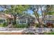 Charming home featuring mature trees, white picket fence, and a welcoming landscaped front yard at 231 15Th Ne Ave, St Petersburg, FL 33704