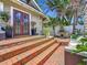 Charming front porch with brick stairs, seating, and lush landscaping at 231 15Th Ne Ave, St Petersburg, FL 33704