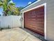 Close up of a garage door in neutral tones with an electric charging station on the side at 231 15Th Ne Ave, St Petersburg, FL 33704