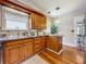 This kitchen features stainless steel counters and a stainless steel sink, along with wooden cabinets at 231 15Th Ne Ave, St Petersburg, FL 33704