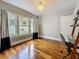 This home office features hardwood floors, a ladder-style desk, and ample natural light at 231 15Th Ne Ave, St Petersburg, FL 33704