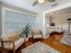 Sunroom features hardwood floors, light paint, plants, and entrance into living area at 231 15Th Ne Ave, St Petersburg, FL 33704