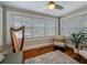 Bright sunroom featuring hardwood floors, neutral paint, many windows, and ceiling fan at 231 15Th Ne Ave, St Petersburg, FL 33704