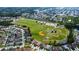 Community aerial view showcasing a large recreational field including baseball diamonds surrounded by residential homes at 2349 Wood Pointe Dr, Holiday, FL 34691