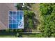 Overhead shot of a sparkling screened pool with jacuzzi and manicured backyard at 2349 Wood Pointe Dr, Holiday, FL 34691