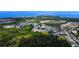An elevated view of a beautiful, well-maintained residential neighborhood surrounded by lush greenery and waterways at 2349 Wood Pointe Dr, Holiday, FL 34691