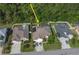 Aerial view of a well-maintained single-Gathering home with a lush, wooded backyard at 2349 Wood Pointe Dr, Holiday, FL 34691