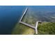 Aerial view featuring a waterfront pier with surrounding wooded area, waters and scenic views at 2349 Wood Pointe Dr, Holiday, FL 34691