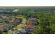 An elevated view of a neighborhood street lined with well-kept homes and manicured landscaping at 2349 Wood Pointe Dr, Holiday, FL 34691