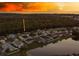 Aerial view showcasing the neighborhood homes near a tranquil lake and surrounded by lush woods at 2349 Wood Pointe Dr, Holiday, FL 34691