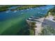Expansive aerial view of a waterfront property with boat docks and numerous boats in the background at 2349 Wood Pointe Dr, Holiday, FL 34691