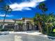 Community clubhouse featuring stone accents, lush landscaping, and a welcoming entrance at 2349 Wood Pointe Dr, Holiday, FL 34691
