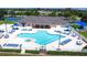 Aerial shot of the community pool and clubhouse with ample seating and a unique flower shape at 2349 Wood Pointe Dr, Holiday, FL 34691