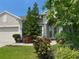 Inviting exterior of home featuring well-manicured landscaping and neutral color scheme at 2349 Wood Pointe Dr, Holiday, FL 34691