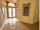 Bright foyer featuring tile flooring, high ceilings, and decorative wall art at 2349 Wood Pointe Dr, Holiday, FL 34691