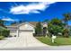 Charming single-story home featuring a three-car garage, well-manicured lawn and mature landscaping at 2349 Wood Pointe Dr, Holiday, FL 34691