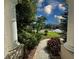 Inviting walkway to front door with lush landscaping and exterior pillars at 2349 Wood Pointe Dr, Holiday, FL 34691