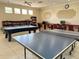 Community game room with library, computers, pool table and ping pong table at 2349 Wood Pointe Dr, Holiday, FL 34691