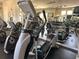 Community gym features cardio equipment, ceiling fans and mirrored wall at 2349 Wood Pointe Dr, Holiday, FL 34691