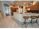 Spacious kitchen with breakfast bar, wooden cabinets, and stainless steel appliances adjacent to dining and living areas at 2349 Wood Pointe Dr, Holiday, FL 34691