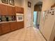 Bright kitchen featuring wooden cabinets, tiled floor, and modern appliances with a pass-through to other rooms at 2349 Wood Pointe Dr, Holiday, FL 34691