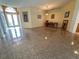 Open-concept living space with tile floors, art, and natural light at 2349 Wood Pointe Dr, Holiday, FL 34691