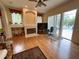 Inviting living room featuring a fireplace, hardwood floors, and sliding glass doors leading to the pool area at 2349 Wood Pointe Dr, Holiday, FL 34691