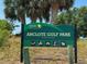 Anclote Gulf Park sign with park activity icons beneath palm trees and clear skies at 2349 Wood Pointe Dr, Holiday, FL 34691