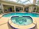 Beautiful backyard with a sparkling pool, relaxing spa, and spacious lanai at 2349 Wood Pointe Dr, Holiday, FL 34691