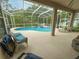 Covered lanai features sparkling pool and spa, lush landscaping at 2349 Wood Pointe Dr, Holiday, FL 34691