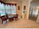 Sitting area with tile flooring, bright window view, decorative curtains, and neutral colored walls at 2349 Wood Pointe Dr, Holiday, FL 34691