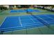 Overhead view of community tennis courts showing the well-maintained blue playing surface at 2349 Wood Pointe Dr, Holiday, FL 34691