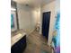 Spacious bathroom with mosaic wall, single sink vanity, and separate toilet room at 2390 Bentley Dr, Palm Harbor, FL 34684