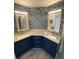 Bathroom vanity features double sinks with decorative mirrors and accent backsplash at 2390 Bentley Dr, Palm Harbor, FL 34684