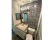 Nicely appointed bathroom with stone vanity, mosaic tile accent wall, and glass shower at 2390 Bentley Dr, Palm Harbor, FL 34684