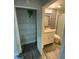 Bright bathroom featuring a white vanity, mosaic tile accent wall, and glass shower at 2390 Bentley Dr, Palm Harbor, FL 34684