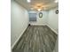Bedroom featuring modern vinyl floors and a window with a window blind at 2390 Bentley Dr, Palm Harbor, FL 34684