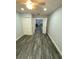 Spacious bedroom with wood-look flooring and direct access to the main living area at 2390 Bentley Dr, Palm Harbor, FL 34684