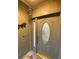 Elegant front door with decorative glass and sidelight, plus a doorbell camera and wind chimes at 2390 Bentley Dr, Palm Harbor, FL 34684