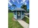 Quaint blue gazebo in a community area, offering a charming spot for relaxation and shade at 2390 Bentley Dr, Palm Harbor, FL 34684