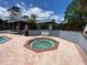 Inviting community hot tub surrounded by a brick patio, offering a perfect spot for relaxation at 2390 Bentley Dr, Palm Harbor, FL 34684