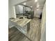 Modern kitchen with breakfast bar, stainless appliances, and eat-in kitchen area at 2390 Bentley Dr, Palm Harbor, FL 34684