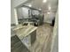 Modern kitchen with granite countertops, stainless appliances, and neutral grey cabinets at 2390 Bentley Dr, Palm Harbor, FL 34684