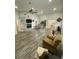Open living space featuring wood-look floors, a fireplace, and an open layout to the kitchen at 2390 Bentley Dr, Palm Harbor, FL 34684