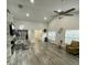 Open living space featuring wood-look floors, a fireplace, and an open layout to the dining area at 2390 Bentley Dr, Palm Harbor, FL 34684