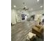 Open living space featuring wood-look floors, a fireplace, and an open layout to the kitchen at 2390 Bentley Dr, Palm Harbor, FL 34684