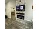 Cozy living area featuring a modern electric fireplace and mounted TV at 2390 Bentley Dr, Palm Harbor, FL 34684