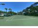 Well-maintained community tennis court with lush greenery and a clear blue sky, ideal for recreation at 2390 Bentley Dr, Palm Harbor, FL 34684