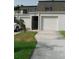 Townhouse exterior featuring garage, front door, and well-maintained landscaping at 2980 Haines Bayshore Rd # 124, Clearwater, FL 33760