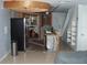 Kitchen remodel, featuring a stainless steel refrigerator, open ceiling and tile flooring at 2980 Haines Bayshore Rd # 124, Clearwater, FL 33760